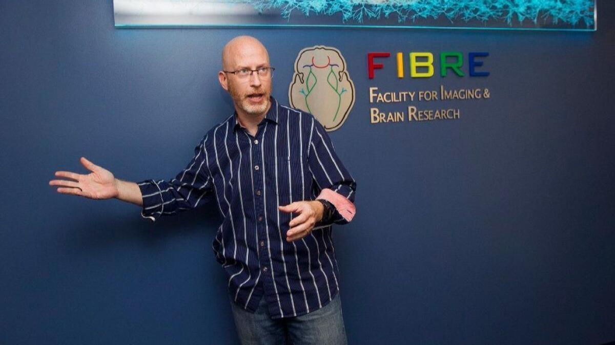 Craig Stark, designer of UC Irvine's FIBRE center and a professor of neurobiology and behavior, gives a tour of the new facility Wednesday.