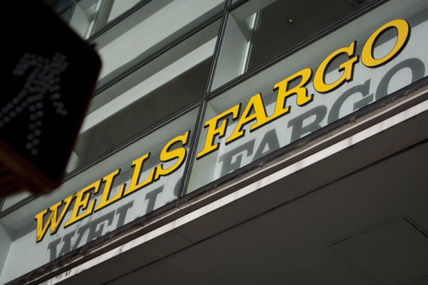 The Wells Fargo & Co. logo is displayed atop a bank branch in New York.