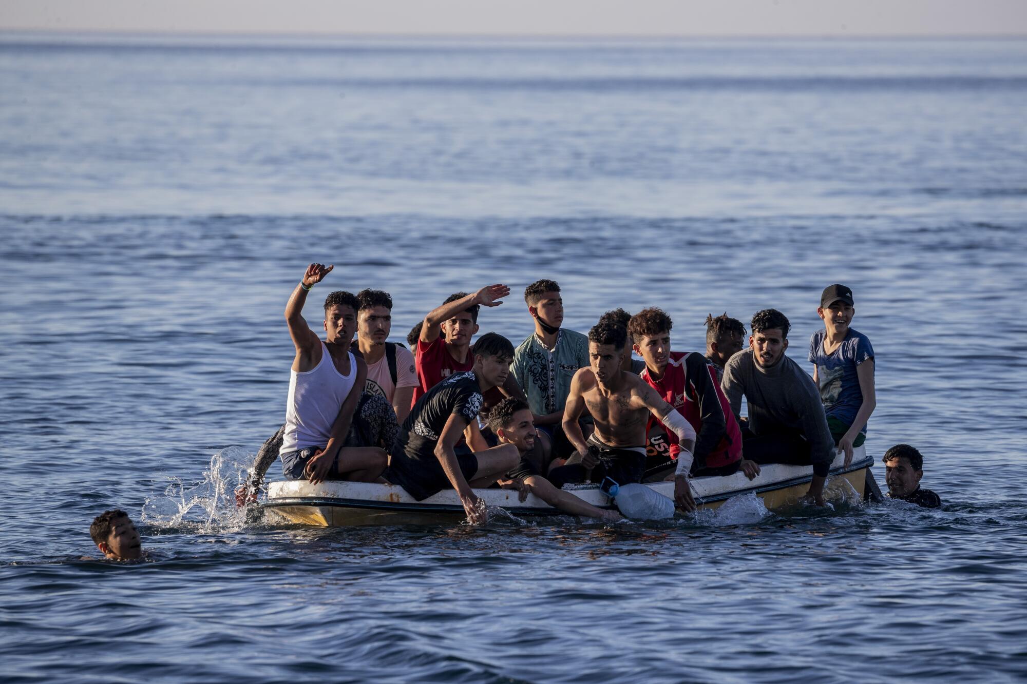 A small boat overloaded with more than a dozen young men and boys