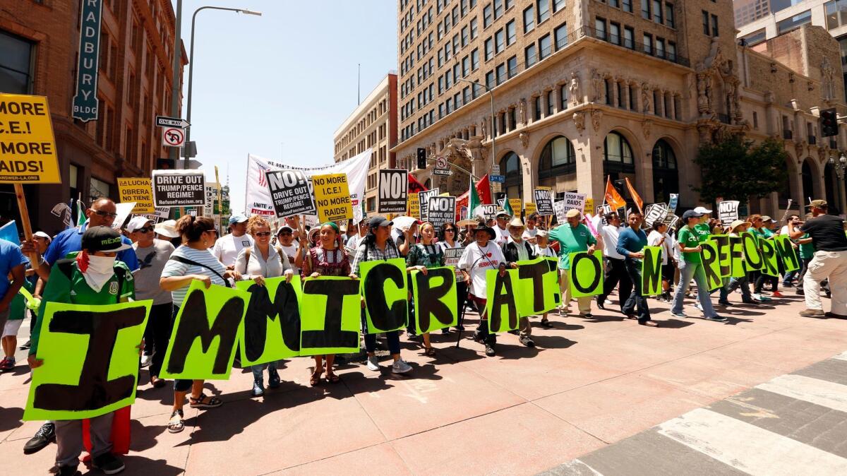 Marchers carry letters spelling out "Immigration reform now" while marching down Broadway during the May Day march in Los Angeles.