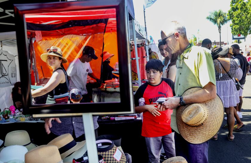 Visitors walk along Adams Aveue during the 40th Annual Adams Avenue Street Fair. The street fair is Southern California's largest free two-day music festival and is held each year in September in Normal Heights and features carnival rides, beer gardens, festival foods and 300 arts and crafts booths.