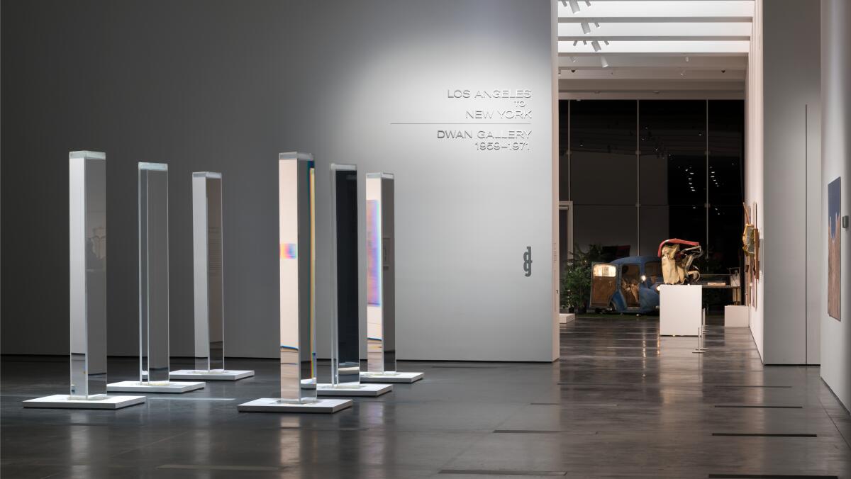 Six reflecting pillars stand in a gallery