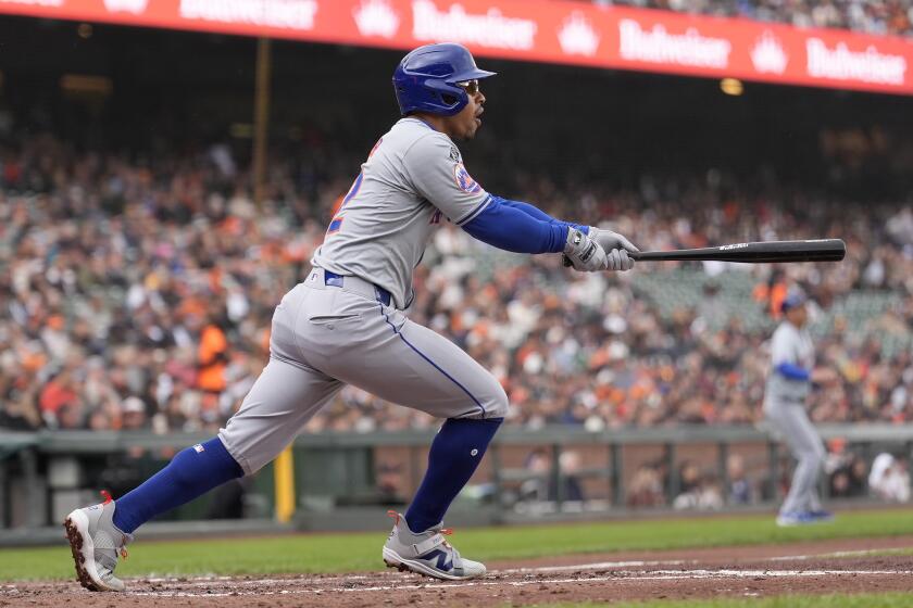 New York Mets' Francisco Lindor watches his two-run home run against the San Francisco Giants during the third inning of a baseball game in San Francisco, Wednesday, April 24, 2024. (AP Photo/Jeff Chiu)