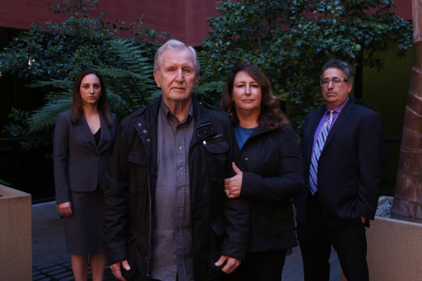 MARINA DEL REY, CA-February 13, 2018: Francis Kerrigan and Carole Meikle, center, are photographed with lawyers Ryan E. Hall, far left, and V. James DeSimone, far right. Kerrigan and Carole contend the Orange County coroner switched one dead homeless man's body for another to cover up a botched death notification last May. The Orange County Sheriff-Coroner has yet to explain how her office misidentified a body found behind a phone store as Frankie M. Kerrigan - a homeless man who later turned up alive on the patio of one of his pallbearers. The coroner later admitted the blunder and said the body that the Kerrigan family buried belonged to John Dickens, 54, another homeless man. Dickens' body was exhumed, and his cremated ashes were sent to his family in Kansas. (Katie Falkenberg / Los Angeles Times)