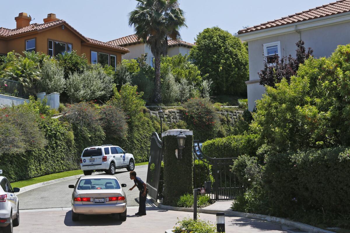 A police officers directs traffic on Paseo de Oro where a woman was wounded and the apparent gunman killed himself.