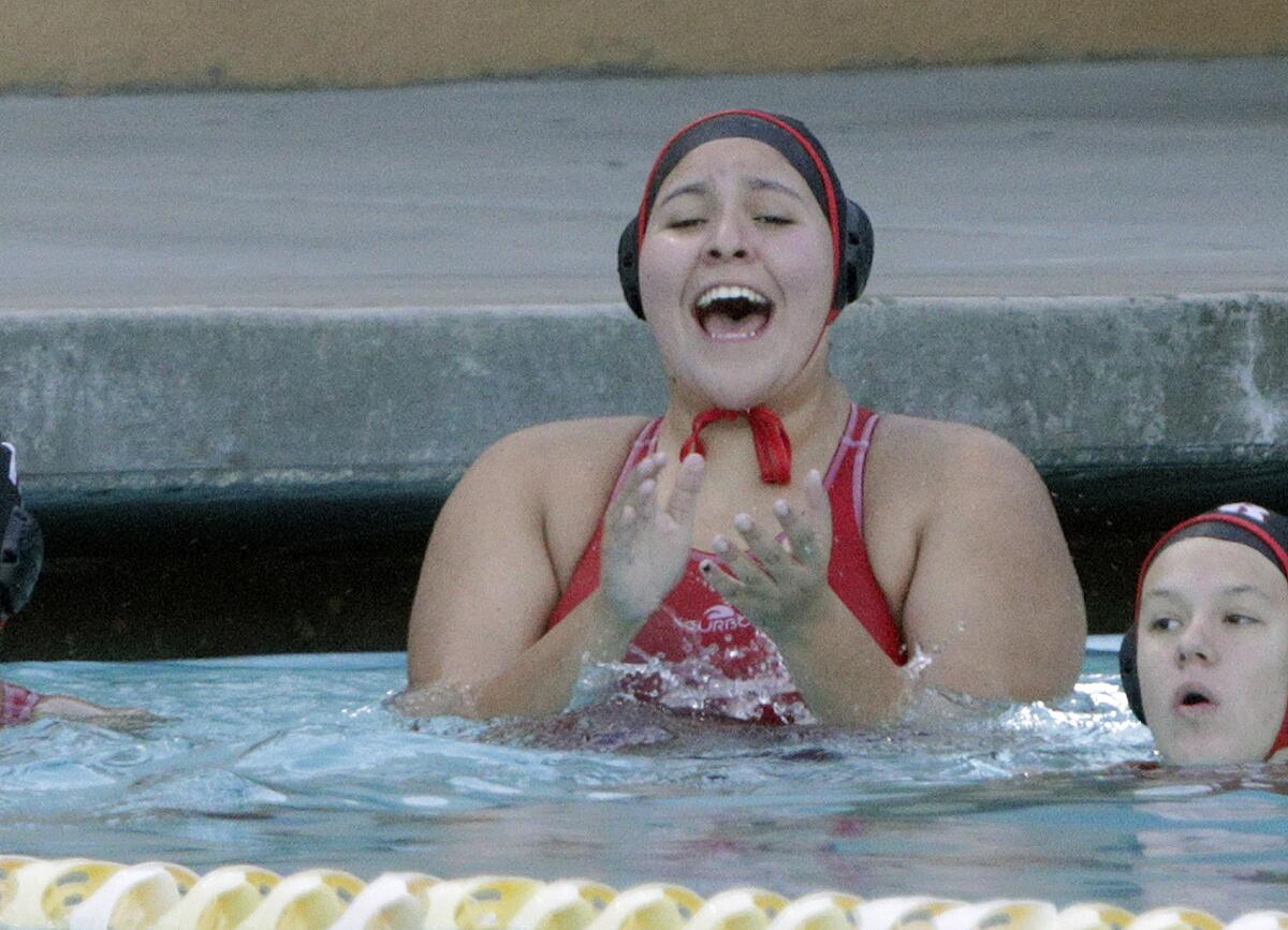 Burroughs' Charlotte Jennings cheers for a Burroughs score against Santa Ana in the first round of the CIF Southern Section Division V girls' water polo playoffs at Burroughs High School on Tuesday, February 11, 2020. Burroughs won the game and advances.