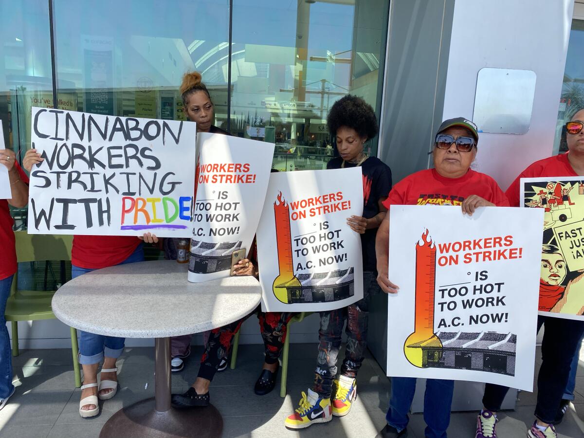 Cinnabon employees protest outside Northridge Fashion Center where they work. 