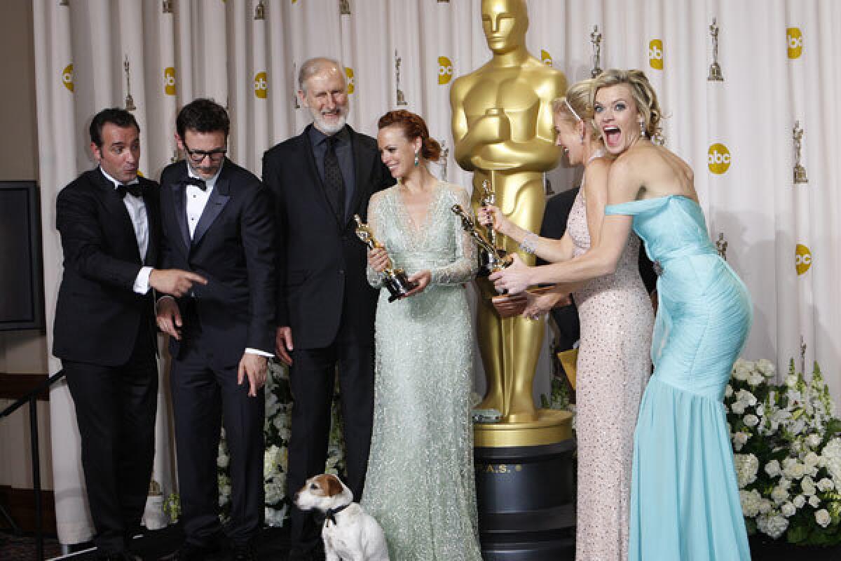 Winners of Best Picture for "Tjhe Artist," left to right, Jean Dujardin, Michel Hazanavicius, James Cromwell, Berenice Bejo, Penelope Ann Miller, Missi Pyle and Uggie the dog at the 84th Annual Academy Awards show at the Hollywood and Highland Center.