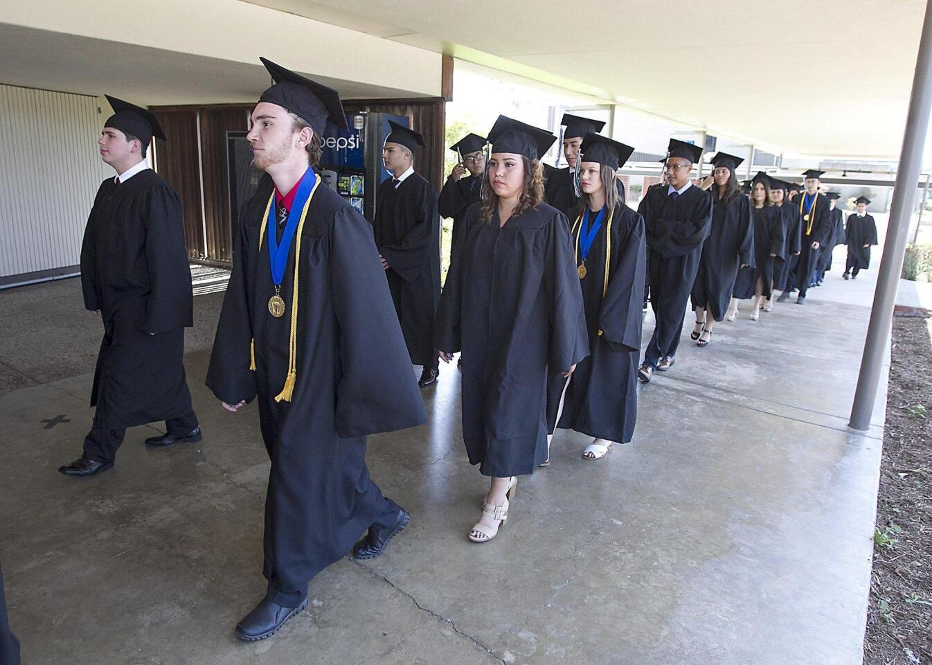 Graduating students walk into the Early College High School’s commencement ceremony Thursday.