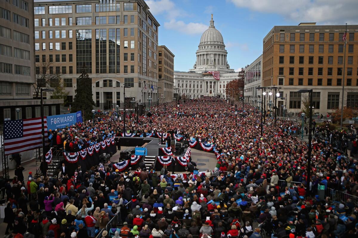People fill the streets in front of the state Capitol building to hear President Obama address a rally during the last day of campaigning in the general election in Madison, Wis.
