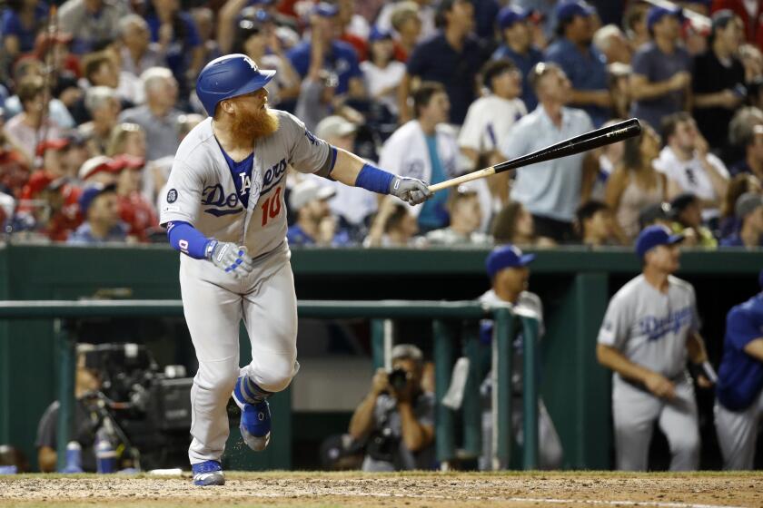 Los Angeles Dodgers' Justin Turner watches his three-run home run in the eighth inning of a baseball game against the Washington Nationals, Friday, July 26, 2019, in Washington. (AP Photo/Patrick Semansky)