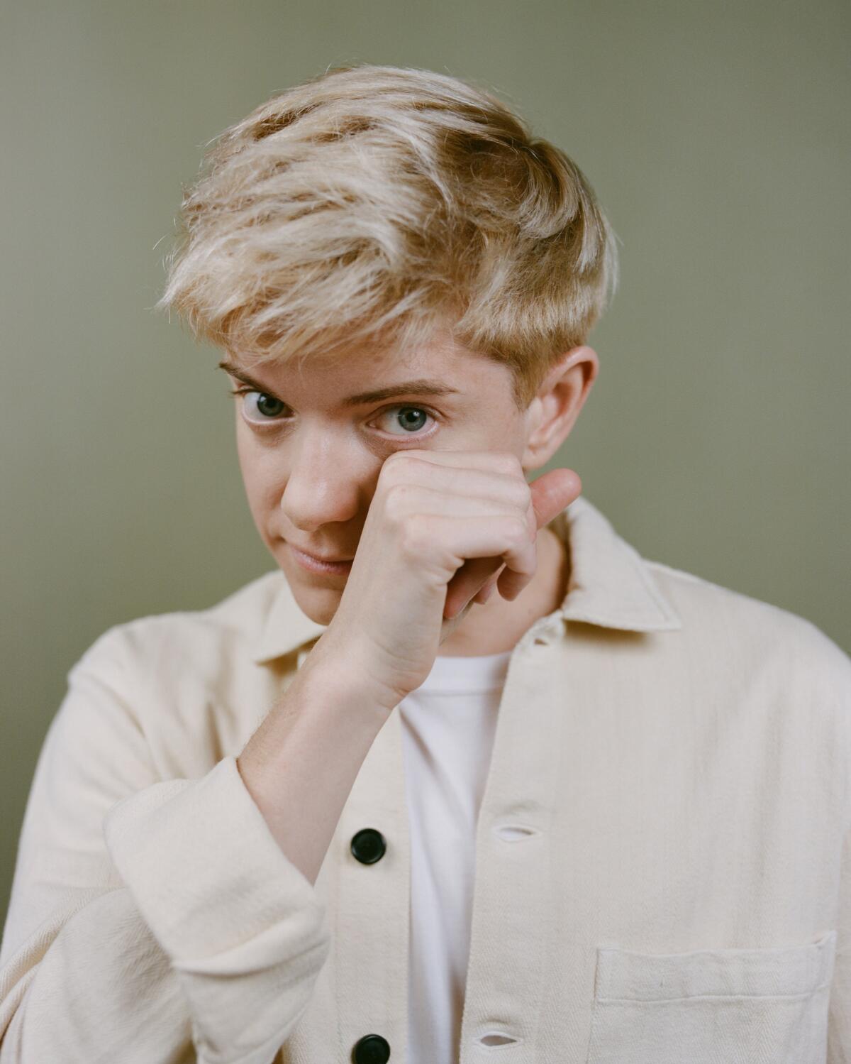 A portrait of comedian Mae Martin, looking directly at the camera.