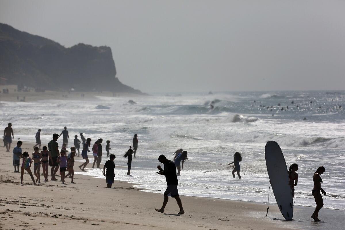 Swimmers and surfers at Zuma Beach in Malibu.