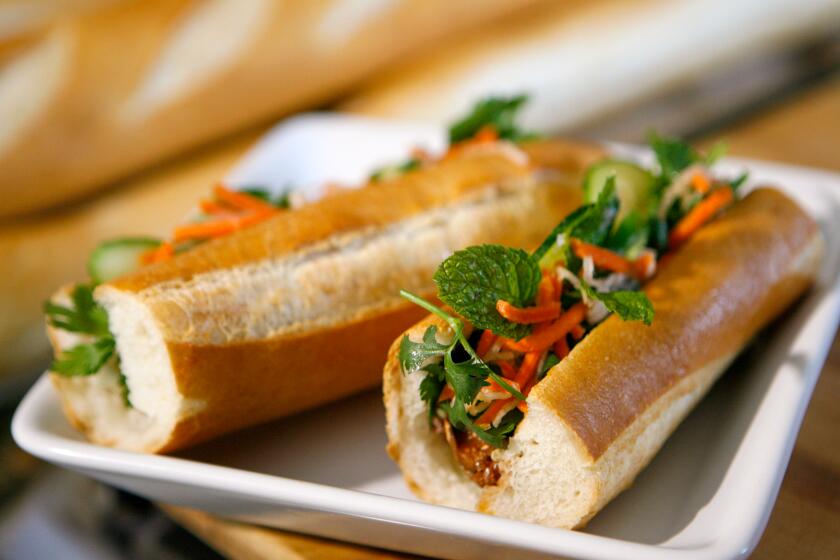 COSTA MESA, CA - OCTOBER 03, 2008: Cooking instructors Todd Porter and Diane Cu show how to make traditional sandwiches using Vietnamese baguette, banh mi on October 3, 2008 in Costa Mesa, Calif. (Myung J. Chun/Los Angeles Times)