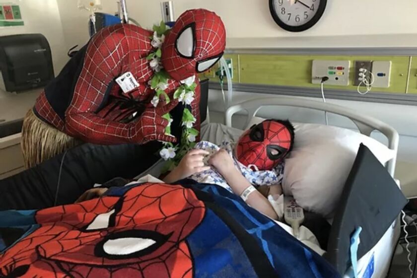 Yuri Williams as Spider-Man during a visit to a child with disabilities in 2019.