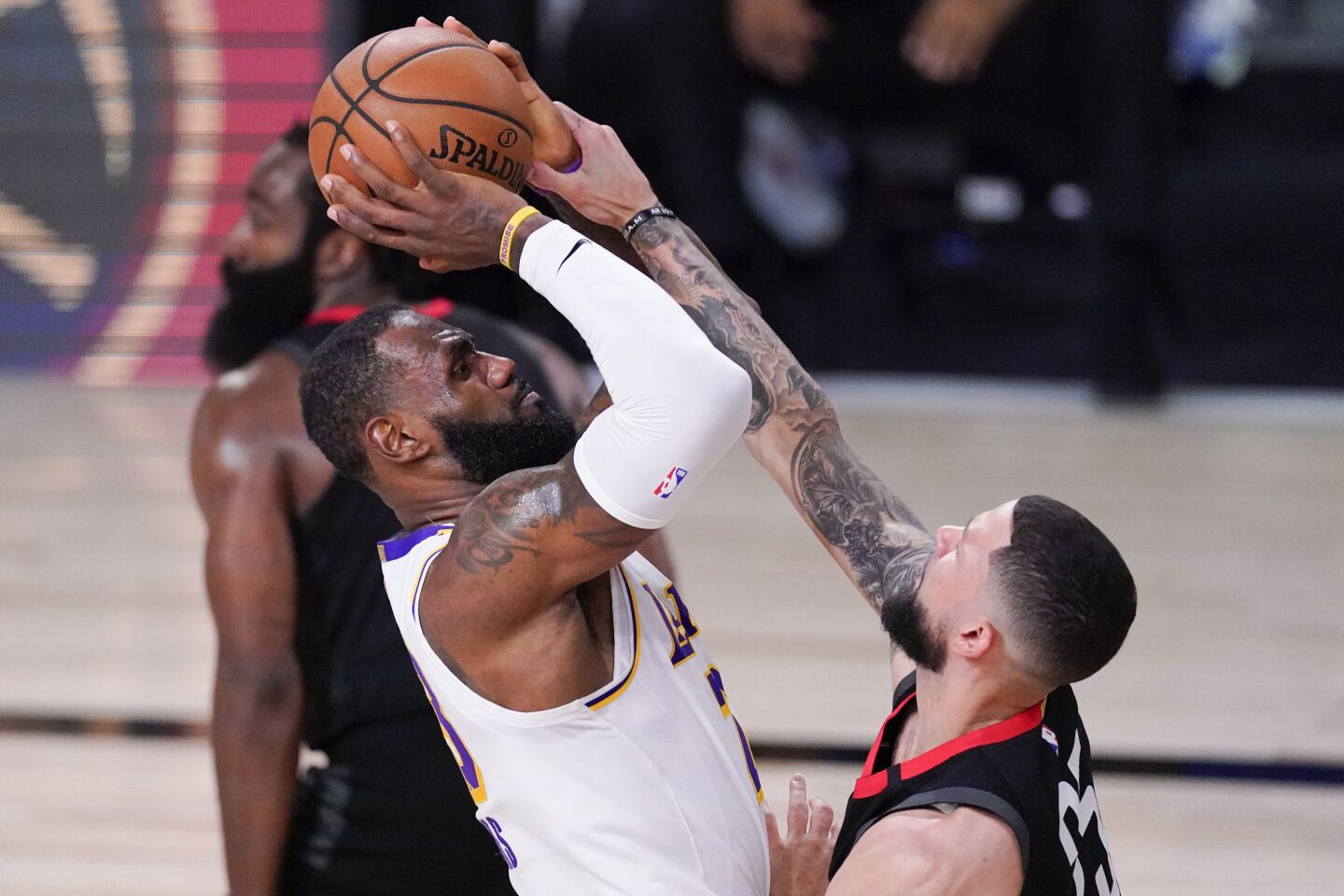 The Lakers' LeBron James goes up for a second-half shot as the Rockets' Austin Rivers defends Saturday.