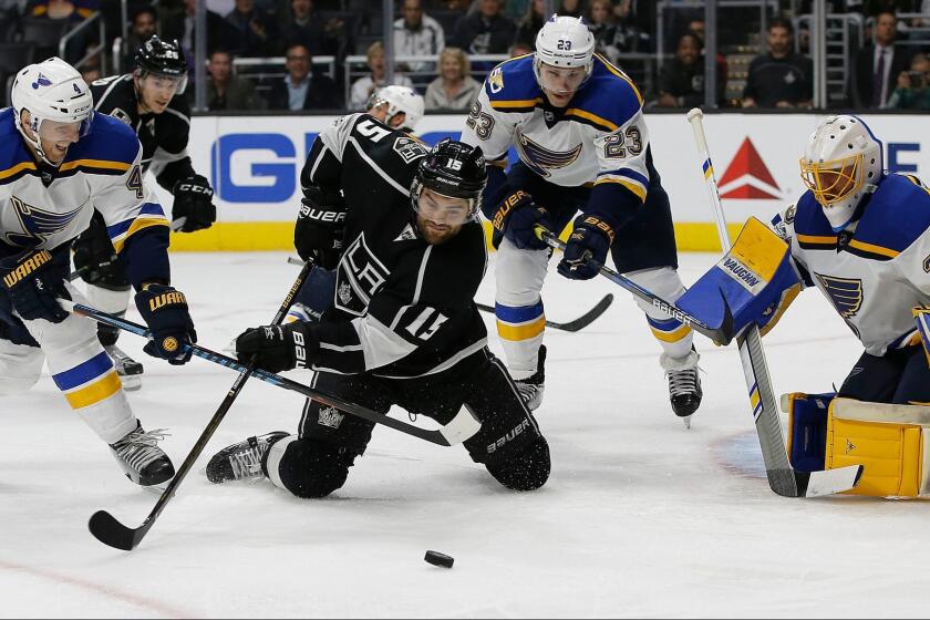 The Kings' Andy Andreoff shoots toward St. Louis goalie Jake Allen, with Carl Gunnarsson (4) and Dmitrij Jaskin (23) defending on March 13.