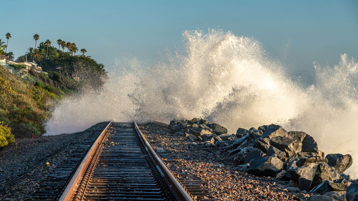 Ocean waves crash over rail tracks in San Clemente.