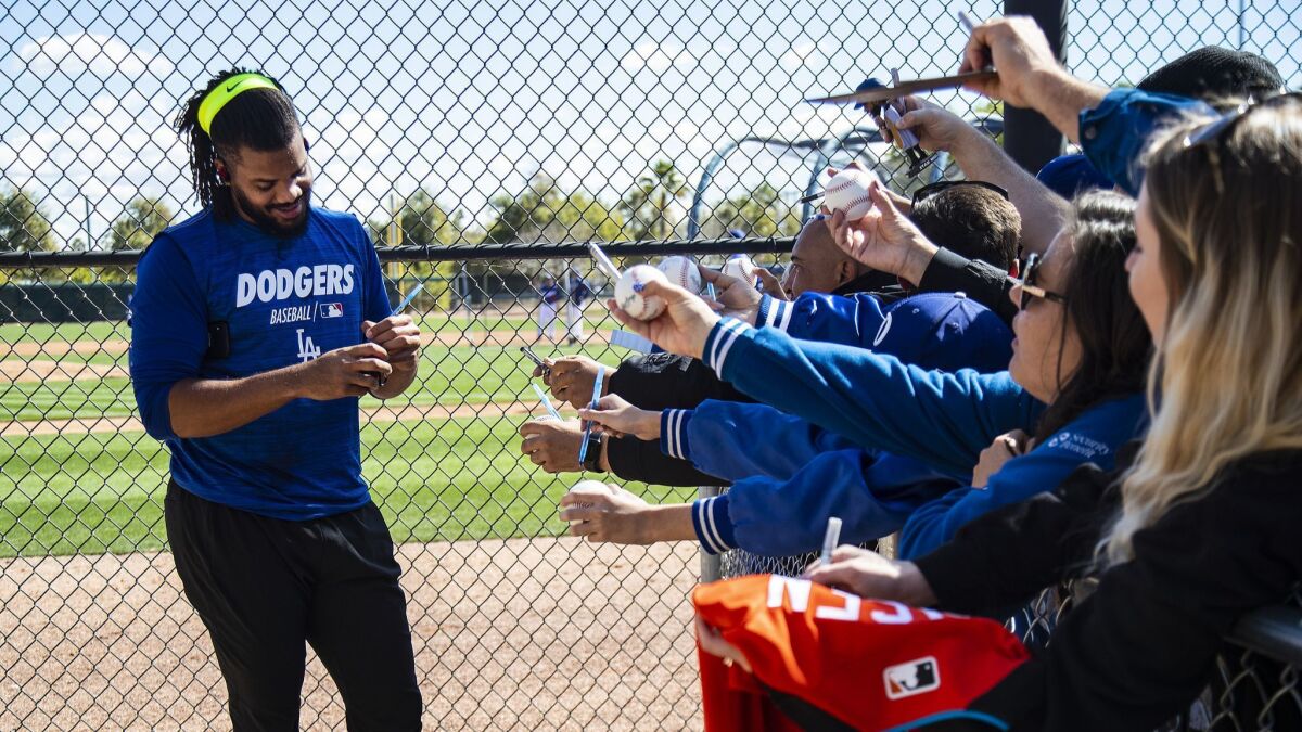 Dodgers pitcher Kenley Jansen signs autographs during spring training at Camelback Ranch on Feb. 19, 2019.