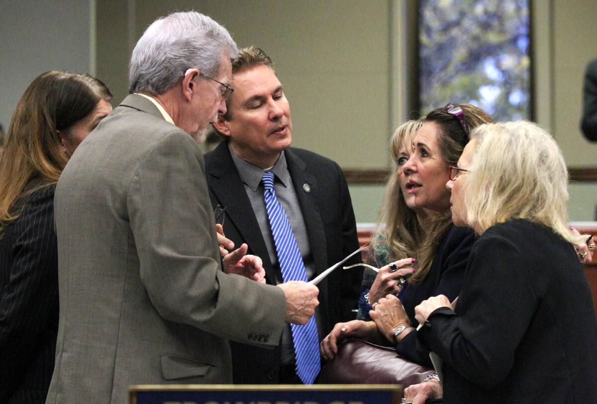 Nevada Assembly Republicans, from left, Shelly Shelton, Glenn Trowbridge, Brent Jones, Jill Dickman, Victoria Seaman and Victoria Dooling talk on the Assembly floor in Carson City, Nev. A hard-fought bill to regulate on-demand transportation companies such as Uber and Lyft got the green light from Nevada lawmakers in the wee hours of Saturday morning, May 23, 2015.