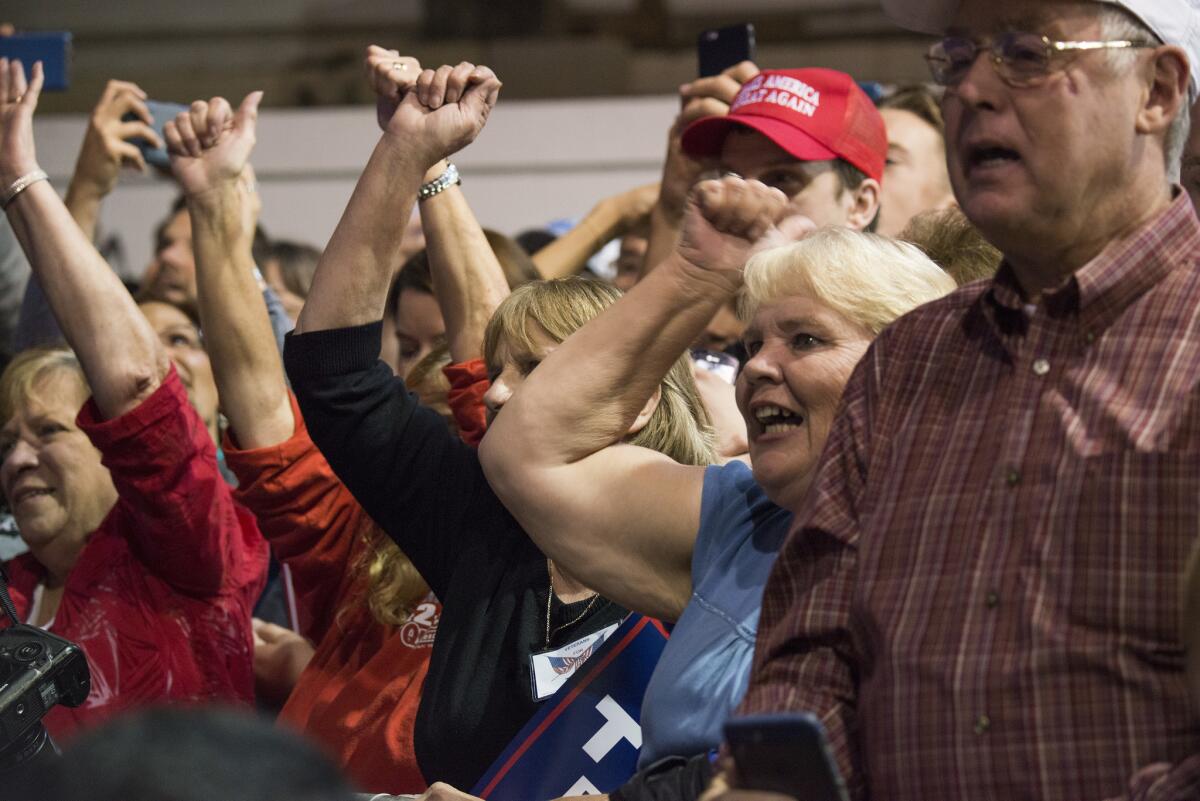Supporters cheer Donald Trump at the county fairgrounds in Delaware, Ohio, on Thursday.