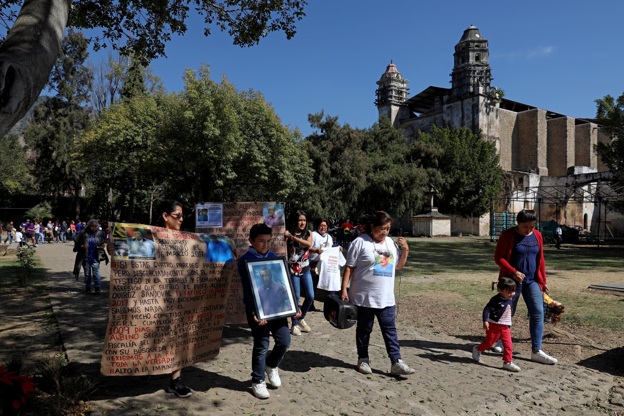 Maricela Peñaloza Flores, center, leads a protest march to the site where her husband Albino Quiroz Sandoval was last seen in Tepoztlán, Mexico, on Dec. 15.