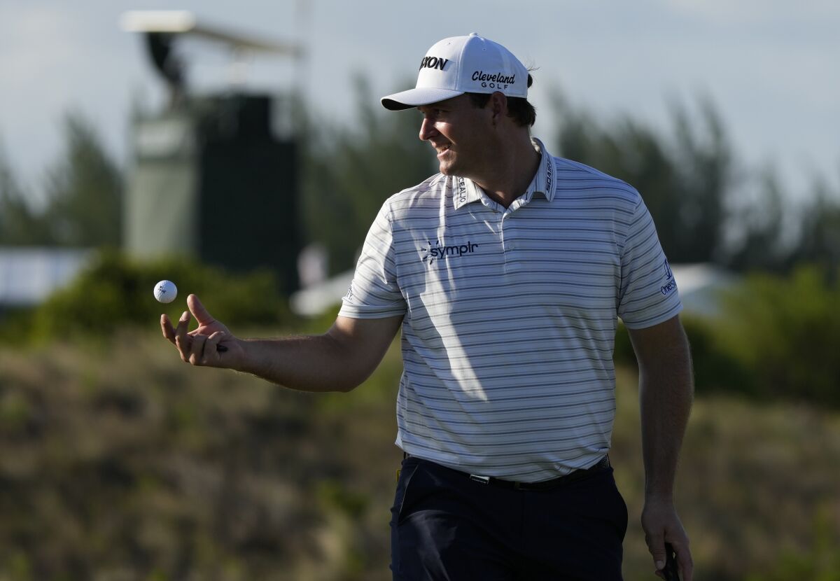 Sepp Straka, of Austria, tosses a ball to his caddie during the first round of the Hero World Challenge PGA Tour at the Albany Golf Club, in New Providence, Bahamas, Thursday, Dec. 1, 2022. (AP Photo/Fernando Llano)