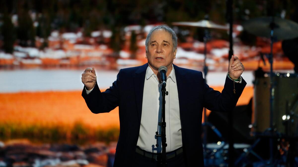 Paul Simon performs "Bridge Over Troubled Waters" on the first night of the Democratic National Convention on Monday, July 25, 2016.