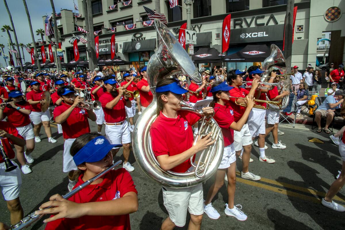 The Huntington Beach Fourth of July Host Band marches up Main Street during Tuesday's parade.