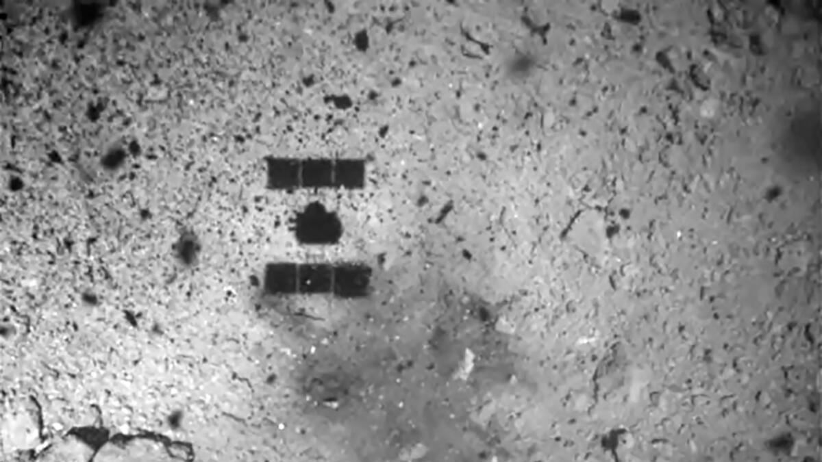 A photo taken by Hayabusa2 shows the shadow of the Japanese spacecraft as it lands on the asteroid Ryugu on Feb. 22.