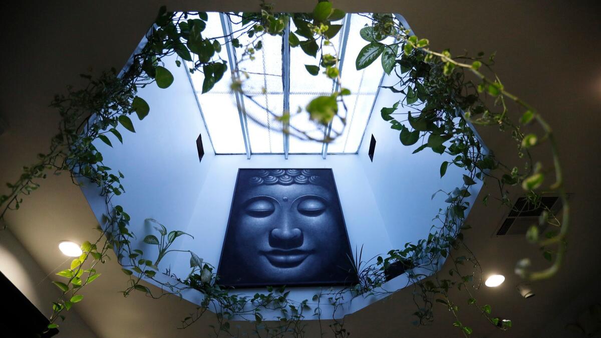 A painting of Buddha hangs inside The Higher Path marijuana dispensary.