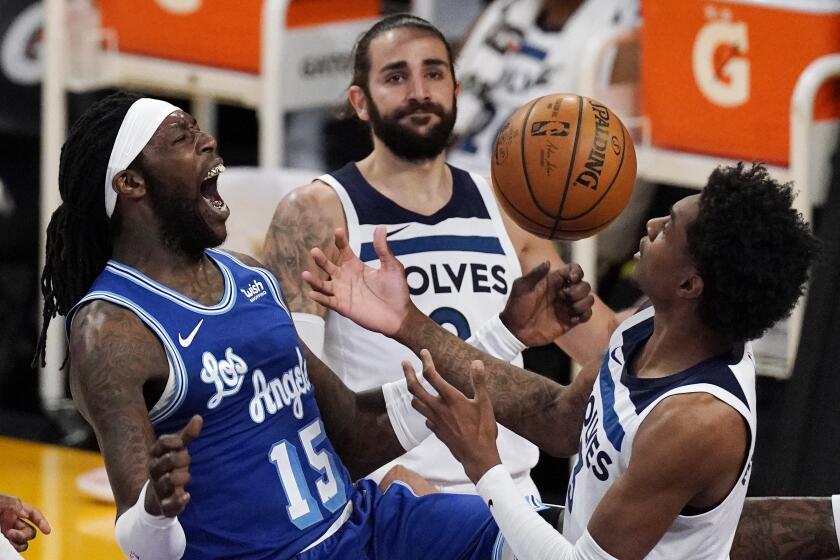 Los Angeles Lakers center Montrezl Harrell, left, celebrates after dunking as Minnesota Timberwolves forward Jaden McDaniels, right, and guard Ricky Rubio watch during the second half of an NBA basketball game Tuesday, March 16, 2021, in Los Angeles. The Lakers won 137-121. (AP Photo/Mark J. Terrill)