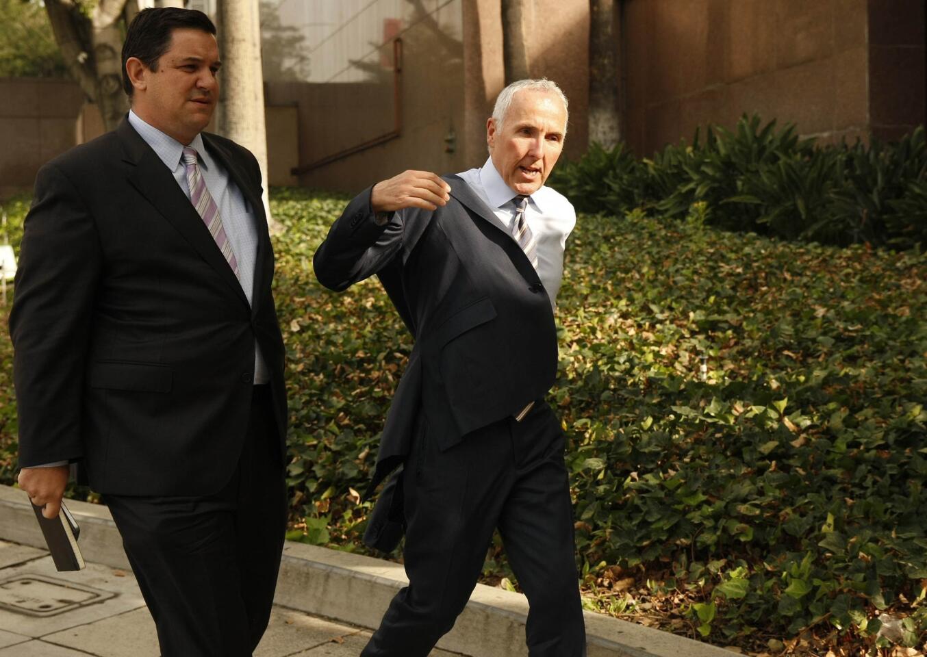 Former Dodgers owner Frank McCourt, right, on June 13 walks into Los Angeles County Superior Court, where he testified in Bryan Stow's lawsuit against the Dodgers.