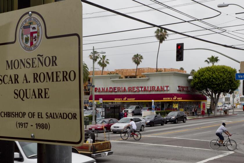 A commemorative plaque for Catholic archbishop Oscar Romero is displayed at the center of Los Angeles' Salvadoran community, where immigrants are pushing for a corridor designation like the Koreatown, Chinatown, and Little Tokyo neighborhoods, in Los Angeles on Monday, April 23, 2012. A bustling Salvadoran population lives south of downtown near the intersection of Pico Blvd. and Vermont Ave., where the square was dedicated Saturday April 21,2012 to Archbishop Romero killed in 1980 during El Salvador's civil war. (AP Photo/Damian Dovarganes)