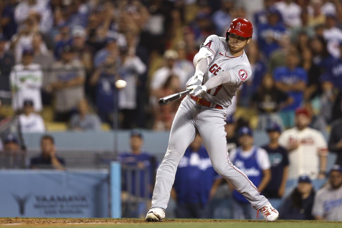 Angels' Shohei Ohtani hits a triple against the Dodgers.