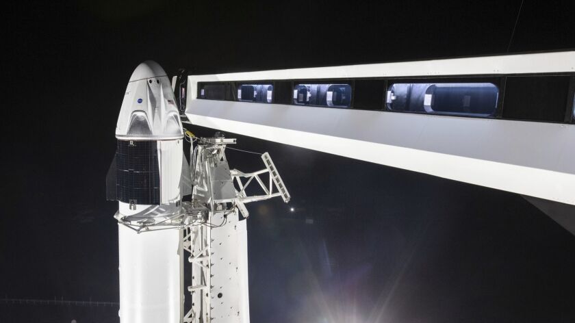 In this Jan. 3 photo provided by SpaceX, the crew access arm is extended to the SpaceX Crew Dragon spacecraft at NASA's Kennedy Space Center.