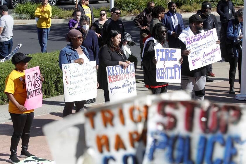 Community members listen to speakers during a rally at Antioch police headquarters in Antioch, Calif., on Tuesday, April 18, 2023. The city council of a small San Francisco Bay Area city voted Tuesday to launch three audits of its troubled Antioch Police Department, the latest development in a year-long federal investigation of the police force that blew up this month with the disclosure of racist text messages among officers. (Jane Tyska/Bay Area News Group via AP)