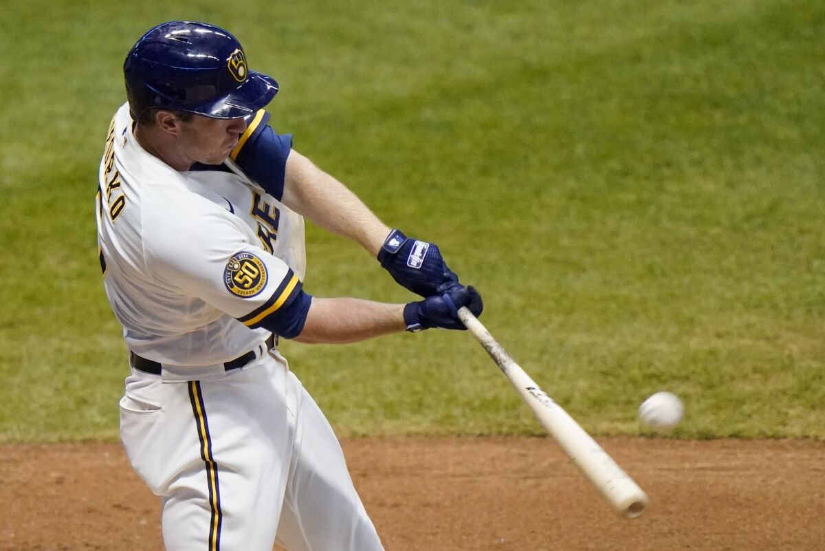 Milwaukee Brewers' Jedd Gyorko hits a two-run home run during the eighth inning of a baseball game against the Minnesota Twins Tuesday, Aug. 11, 2020, in Milwaukee. (AP Photo/Morry Gash)
