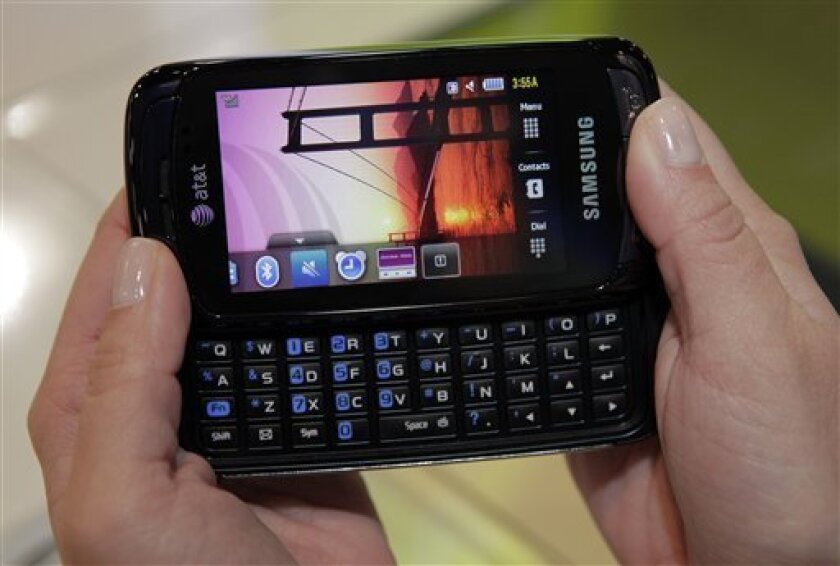 The Samsung Impression, the first phone on the U.S. market with a screen that uses organic light-emitting diodes rather than liquid crystals, is shown at the International CTIA Wireless show in Las Vegas, Wednesday, April 1, 2009. The shift from numerical keypads to alphabetic keyboards, which has overturned cell phone design in the space of a two years, is a recognition of the popularity of text messaging, and to a lesser extent, wireless Internet use. (AP Photo/Jae C. Hong)