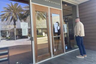 Interior designer Bobby Smith peers through the window of the temporarily shuttered PIRCH store at Westfield UTC.