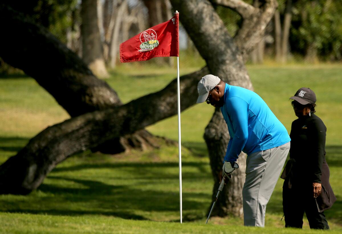A golfer prepares to chip onto a green at Maggie Hathaway Golf Course.
