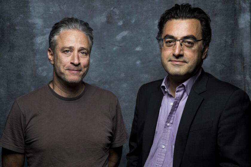 Director Jon Stewart, left, and journalist Maziar Bahari promote their film, "Rosewater," at the Toronto International Film Festival on Sept. 8, 2014.