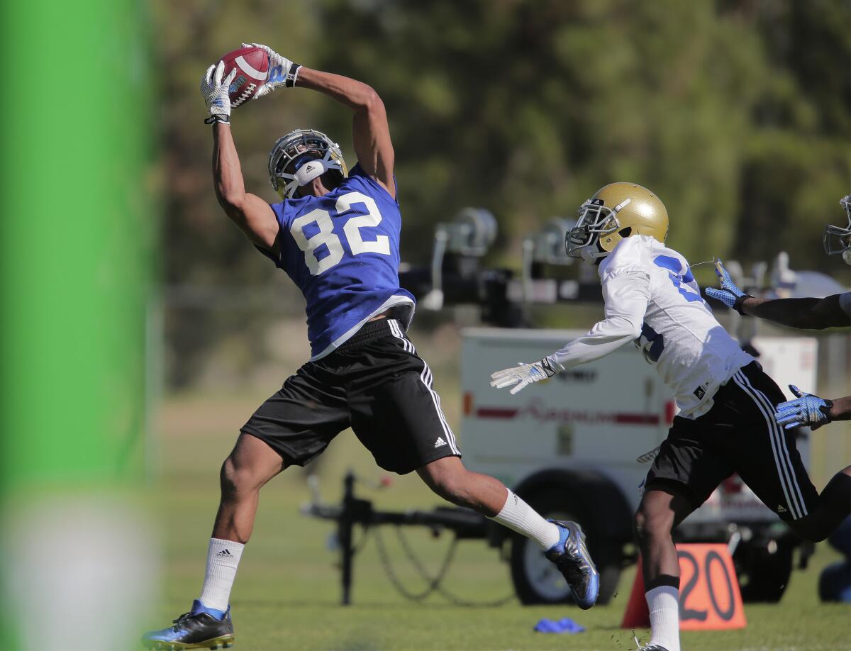 UCLA receiver Eldridge Massington (82) makes a goal line catch during the first day of the Bruins' camp at Cal State San Bernardino on Aug. 10.