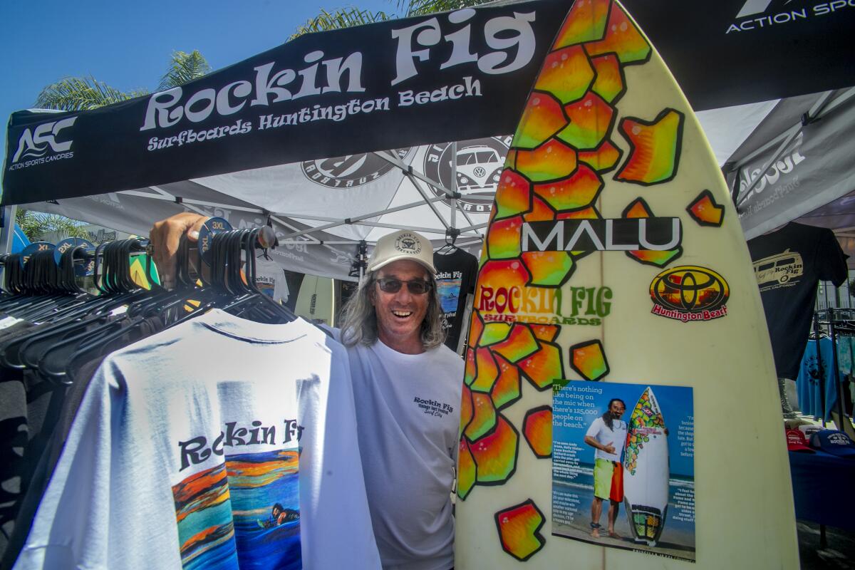 Michael Fernandez poses at the exhibit for the Rockin' Fig Surf Surf Shop.
