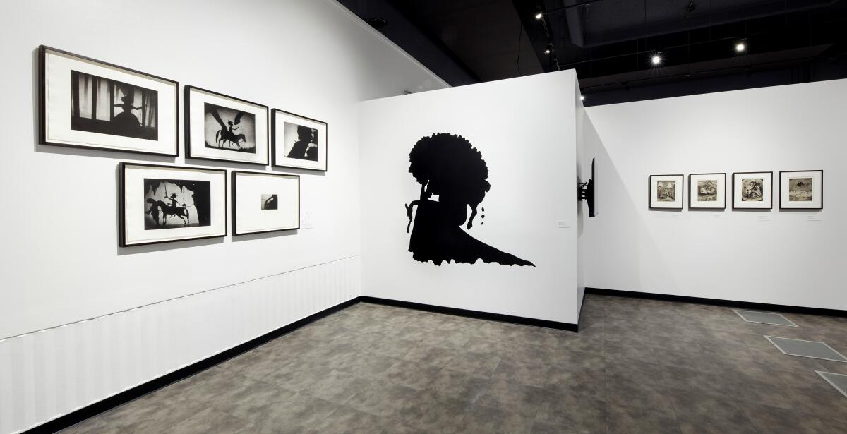 An art gallery filled with black-and-white works.