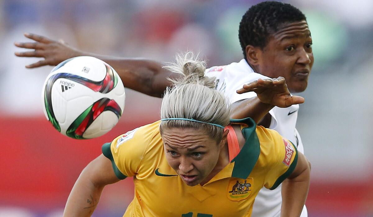 Australia's Kyah Simon, left, and Nigeria's Ugo Njoku go for the ball during a FIFA Women's World Cup match on Sunday. Njoku is expected to get a lengthy suspension for elbowing Australia’s Samantha Kerr during the match.