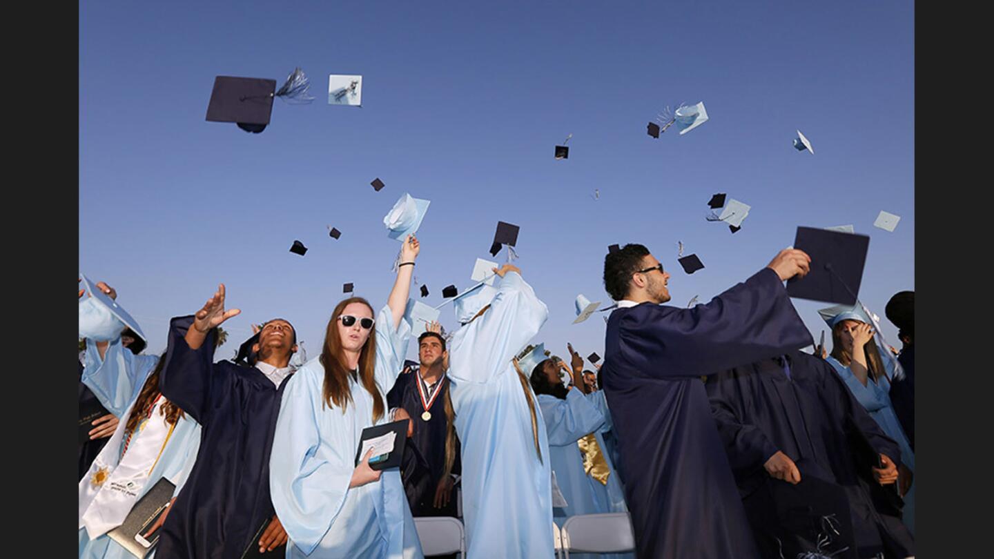 Crescenta Valley High School graduates throw their caps up in the air to celebrate their graduation during the Commencement for the class of 2017 at the school's field in La Crescenta on Thursday, June 1, 2017.