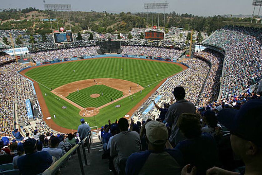 Fans cheer at a sold-out opening day game at Dodger Stadium in Elysian Park, in the central region of Los Angeles.