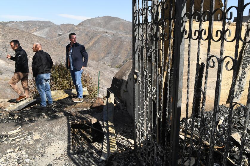 BRENTWOOD, CALIFORNIA OCTOBER 29, 2019-From left, L.A. Mayor Eric Garcetti, L.A. City Councilman Mike Bonin and California Governor Gavin Newsom view a burned and home along Tigertail Road in Brentwood Tuesday. (Wally Skalij/Los Angeles Times)