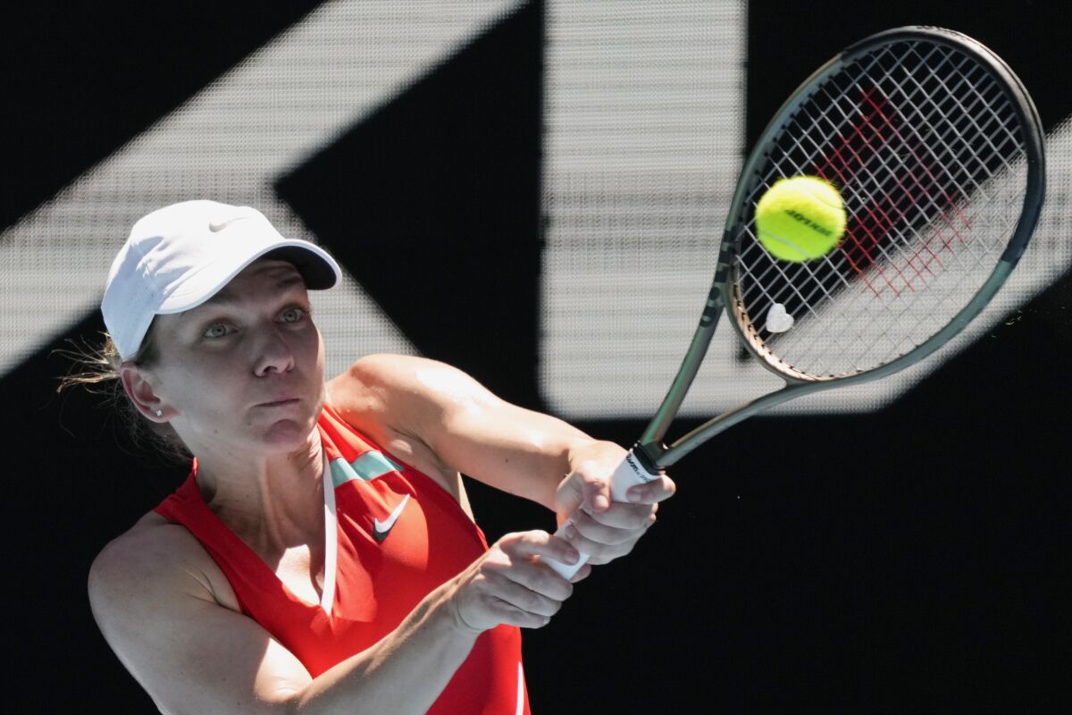 Simona Halep of Romania plays a backhand return to Danka Kovinic of Montenegro.
